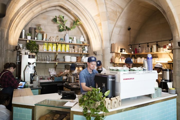 A barista works at a Bluestone Lane coffee shop.